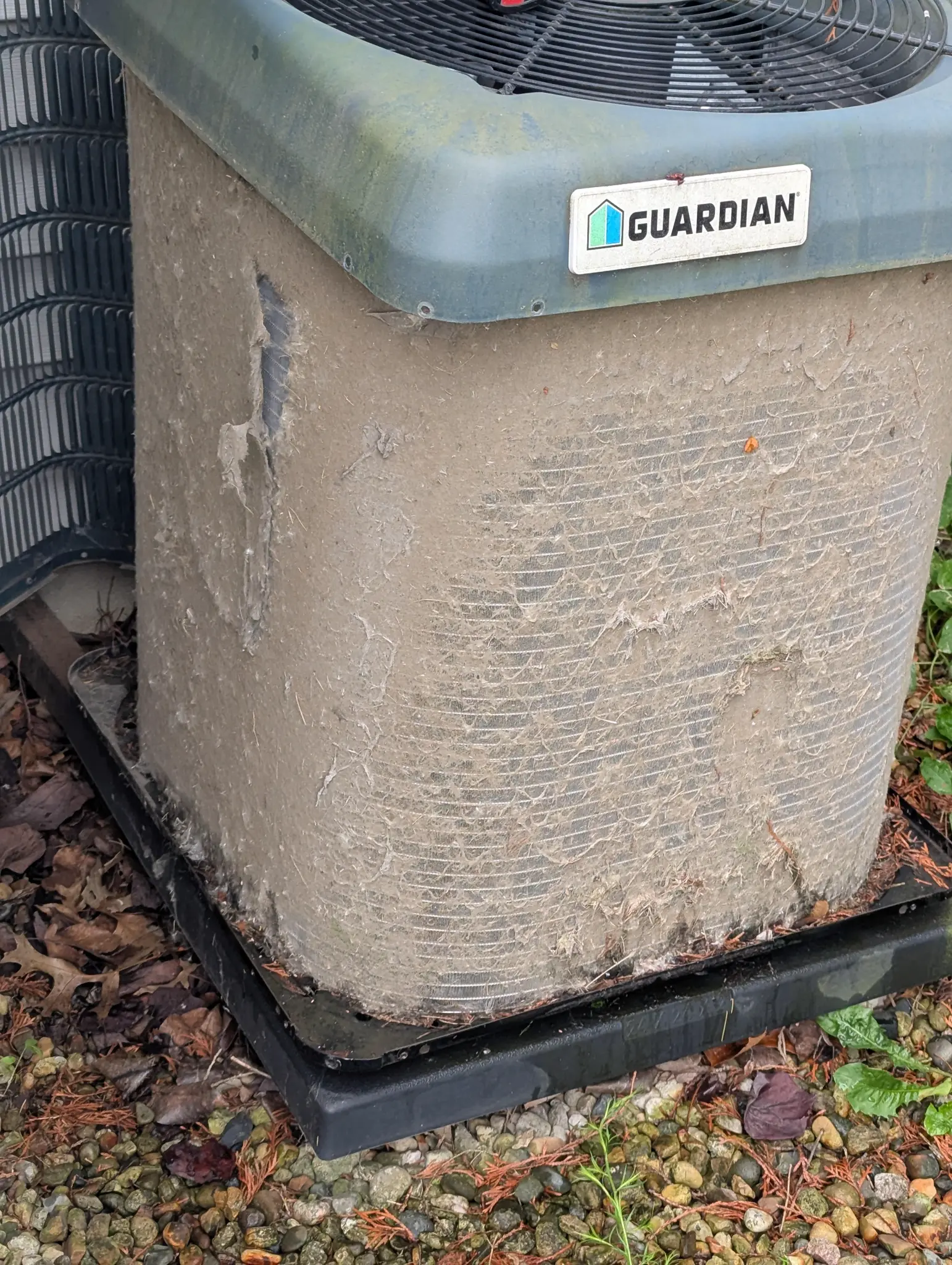 Guardian outdoor air conditioning unit beside a home