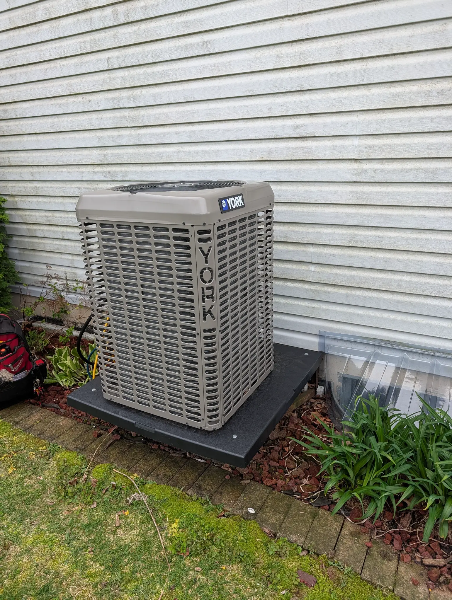 York outdoor condenser beside light-colored siding